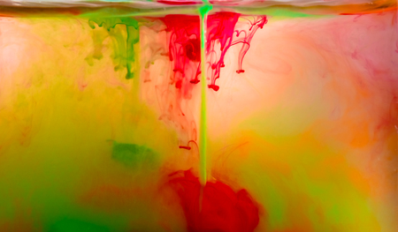 Colorful ink swirling in waterの写真素材