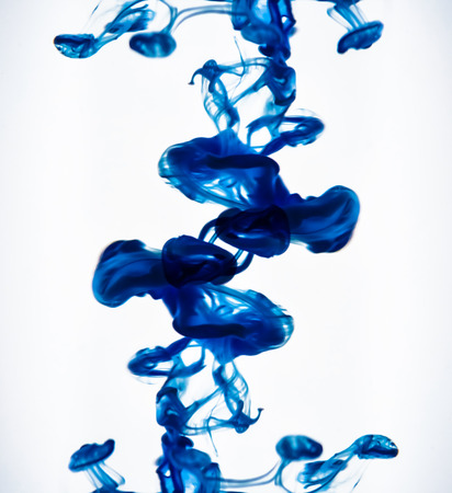 Colorful ink swirling in waterの写真素材