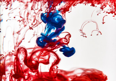 Colorful ink swirling in waterの写真素材