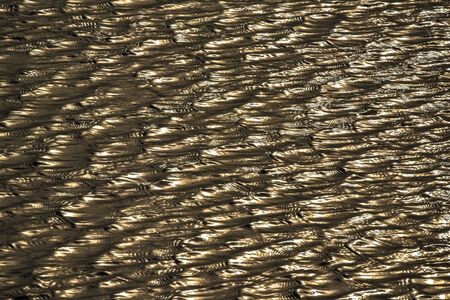 Bokeh sparkling on the waves of the water blurred abstract background