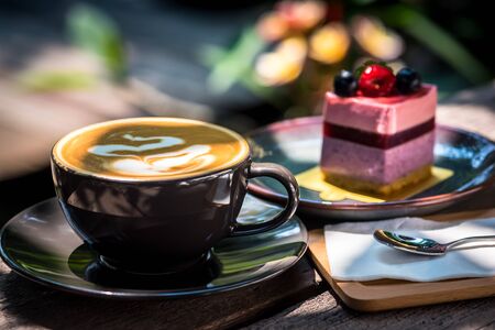 Breakfast with coffee and blueberry cheesecake on the garden terrace