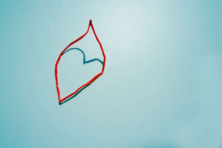 heart-shaped shadow made by light shining through a ropeの写真素材