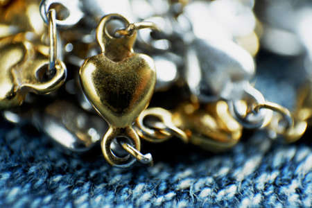 Close-up shot of gold  heart on blurred backgroundの写真素材