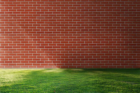 Nature green grass and red brick wall with copy space for background.