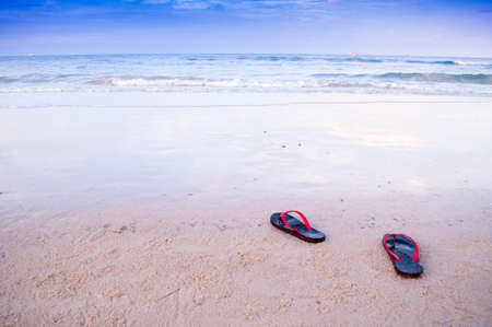 A shoes on beach along sea and blue skyの写真素材