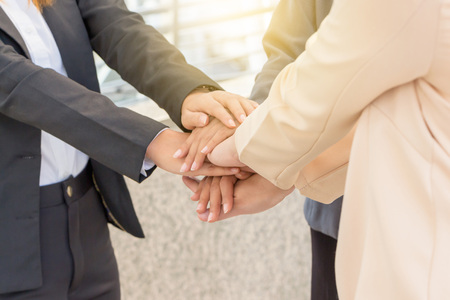 Success Teamwork Concept, Business people joining hands city background.