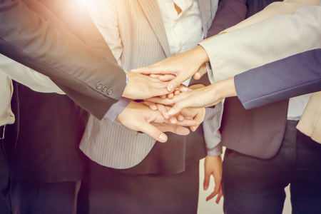 Success Teamwork Concept, Business people joining hands city background.