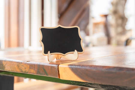 Blank photo frames display on the wooden table in coffee shop for your designの写真素材