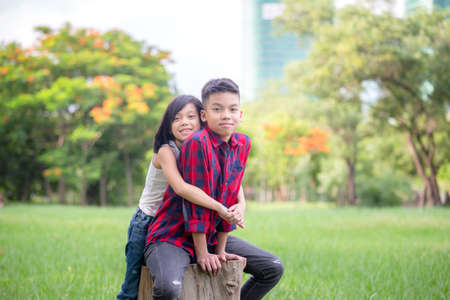 Cheerful brothers and sister playing in the park, Outdoor learning conceptの写真素材