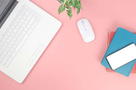 Top view with copy space of Laptop notebook and smartphone on books overhead on pink pastel background, Flat lay and Mock up conceptの写真素材