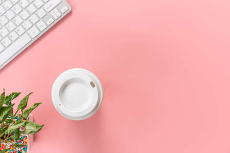 Top view with copy space of Computer keyboard and coffee mug overhead on pink pastel background, Flat lay conceptの写真素材