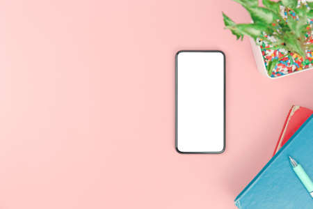 Top view with copy space of smartphone books and pen overhead on pink pastel background, Flat lay and Mock up conceptの写真素材