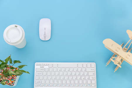 Top view with copy space of Computer keyboard and coffee mug overhead on blue pastel background, Flat lay conceptの写真素材