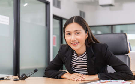 Happiness and smiling young beautiful businesswoman with headphones, Professional operator service conceptの写真素材