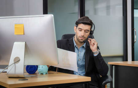 Happiness and smiling young beautiful business man with headphones, Professional operator service conceptの写真素材