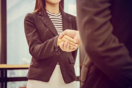 Success and Happiness Team Concept, Businessman handshake finishing up a meetingの写真素材