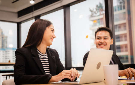 Cheerful young business partners discussing documents and ideas at meeting room, Successful and teamwork conceptの写真素材