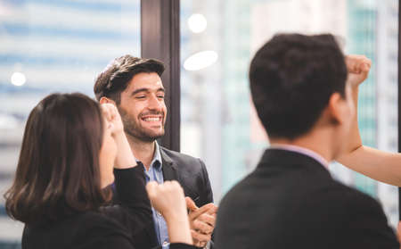 Happy business people celebrating success at company, Successful young business team achieving goalsの写真素材