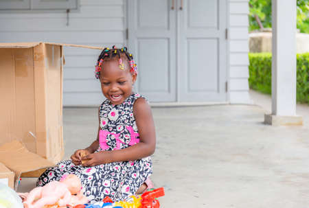 Cheerful little kid girl playing toys with joy, Happiness family conceptの写真素材