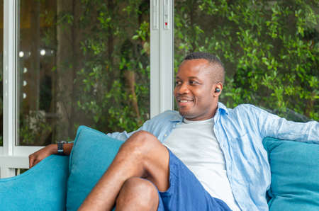 Cheerful african american casual man in living room, Happiness family conceptsの写真素材