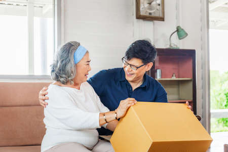 Senior asian mother and middle aged son sitting relax in living room on moving day, Happiness Asian family conceptsの写真素材