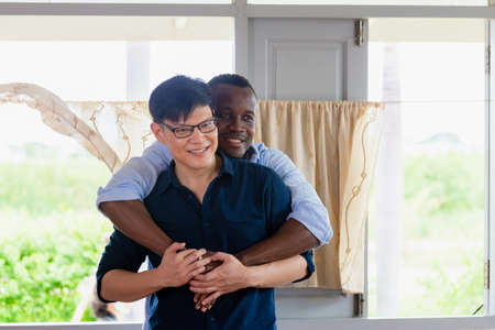 Happy gay couple homosexual hugging at home, LGBT conceptの写真素材
