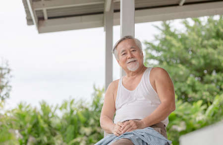 Senior asian man sitting relax and looking at cameraの写真素材