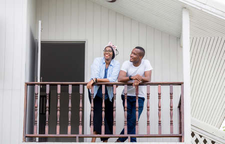 Cheerful african american couple at wooden balcony, happiness family conceptsの写真素材