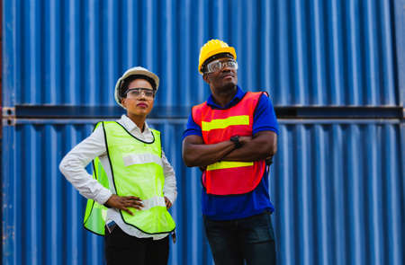Cheerful female shipping company workers working at the harbor, Cheerful factory worker man smiling with arms crossedの写真素材