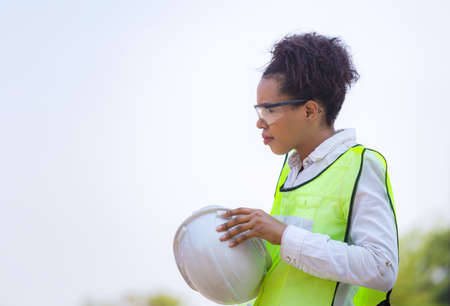 Cheerful factory worker woman in hard hat smiling, Happiness Female engineers for conceptの写真素材