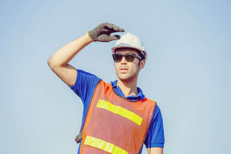 Cheerful shipping company workers working at the harbor, Engineering man looking to the skyの写真素材