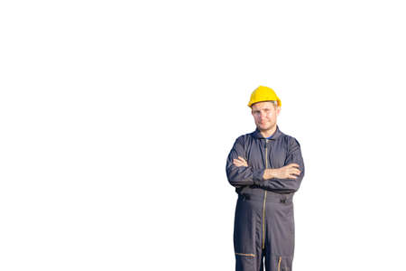 Cheerful factory worker man with clipping path in hard hat smiling with arms crossed as sign of Successの写真素材