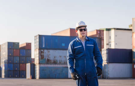 Cheerful factory worker man in hard hat smiling and looking at camera with joy, Happiness conceptの写真素材