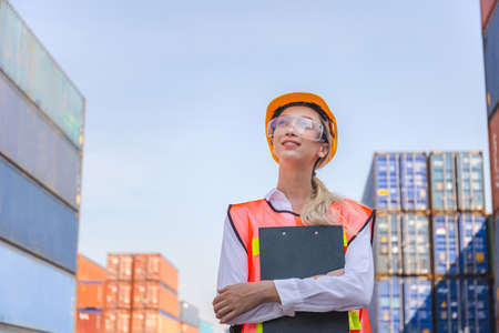 Cheerful factory worker woman in hard hat smiling and looking to the sky, Happiness Female engineers for conceptの写真素材