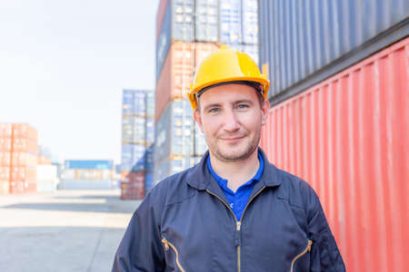 Cheerful factory worker man in hard hat smiling and looking at camera with joy, Happiness conceptの写真素材