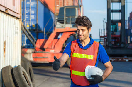 Cheerful factory worker man smiling with giving thumbs up as sign of Successの写真素材