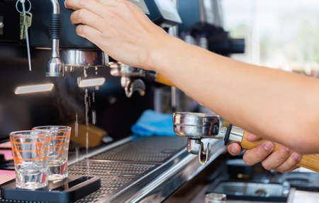 Close up of Barista hand making coffee on the machineの写真素材