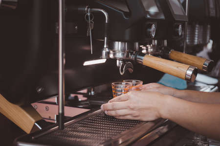 Close up of Barista hand making coffee on the machineの写真素材