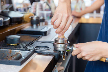 Close up of Barista hand making coffee on the machineの写真素材