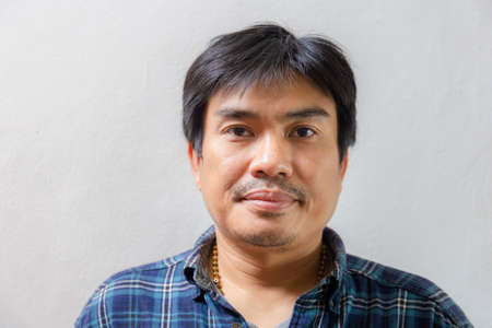 Cheerful asian casual man smiling and looking at camera with joy, Happiness conceptの写真素材