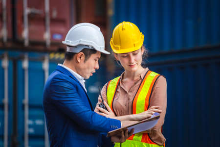 Engineer and worker team checking containers box from cargo, Logistic and teamwork conceptの写真素材