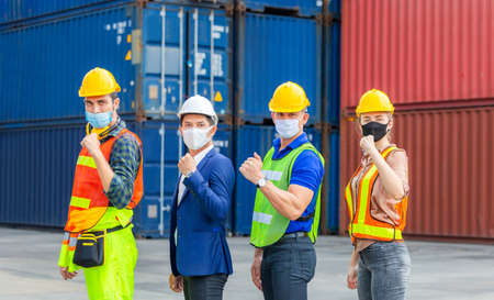 Engineer and worker team wearing protection face mask against coronavirus, Business people team...