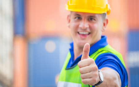 Cheerful engineer man smiling with giving thumbs up as sign of Success