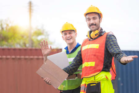 Happy factory worker man team in hard hat smiling and looking at camera with joy, Happiness and funny conceptの写真素材