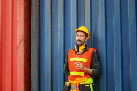 Factory worker with a cigarette smoke break, Labour takes a cigarette breakの写真素材