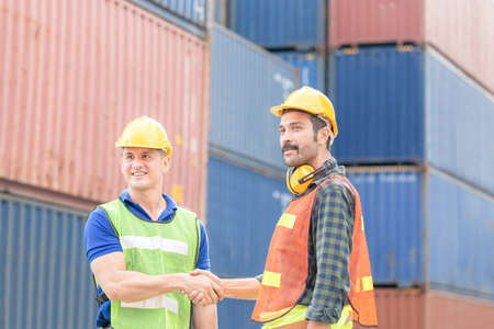 Engineer and foreman worker handshake with blurred construction site, Success and Teamwork conceptの写真素材