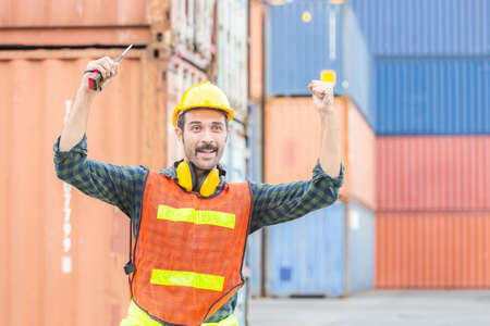 Engineer man in hard hat celebrating victory, foreman worker raise hands in celebration