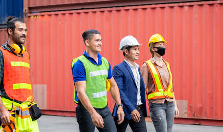 Engineer and worker team walking in the cargo container