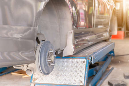 Mechanic fixing the wheel alignment device onto a car wheel of new tire replacementの写真素材