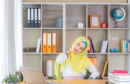 Happiness young business arab middle eastern muslim woman relaxing at comfortable office chair, Work from  home conceptsの写真素材